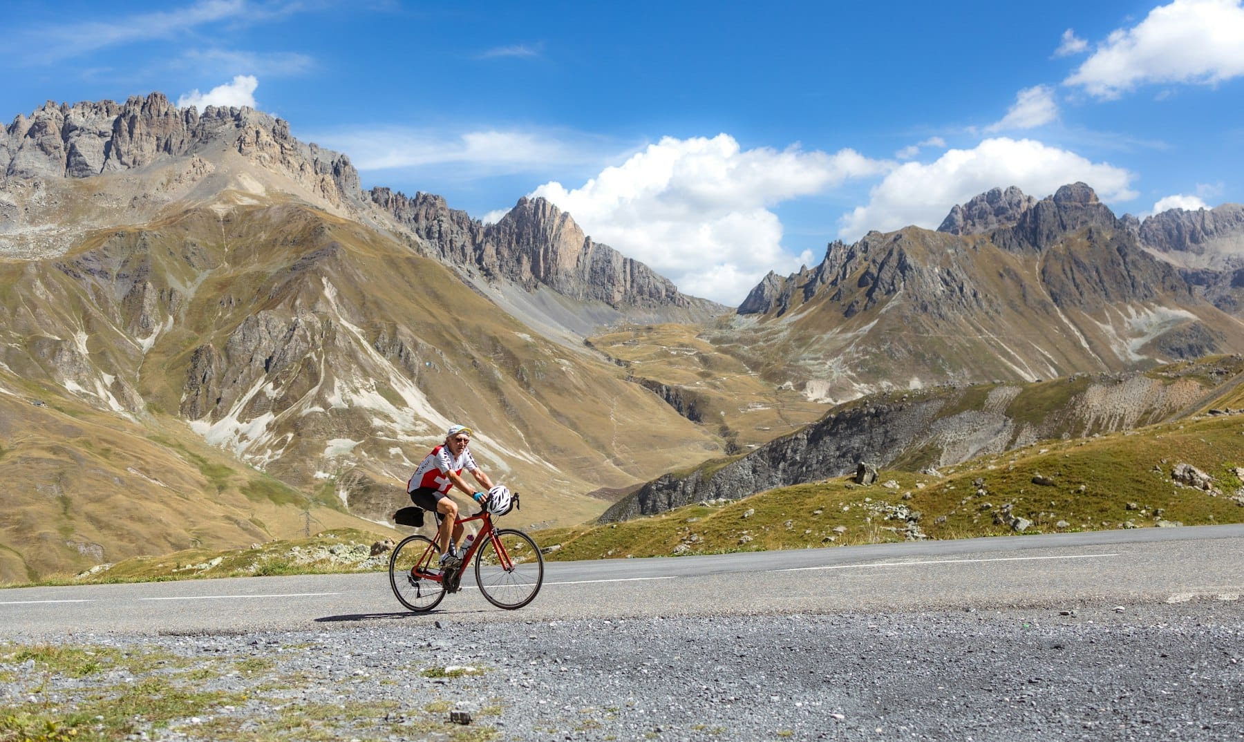 A cyclist riding through a mountain landscape
