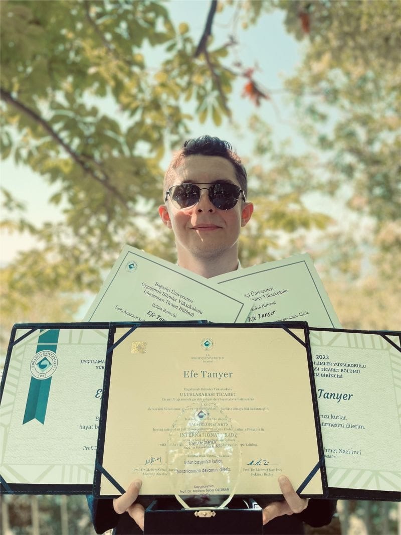 Efe Tanyer holding his Boğaziçi University graduation diplomas